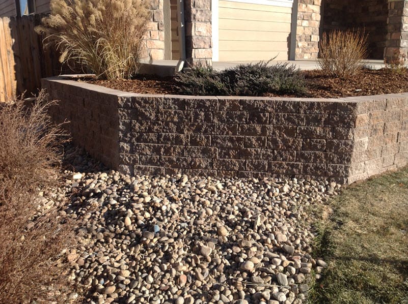 Retaining wall on a property with a planted terrace on top